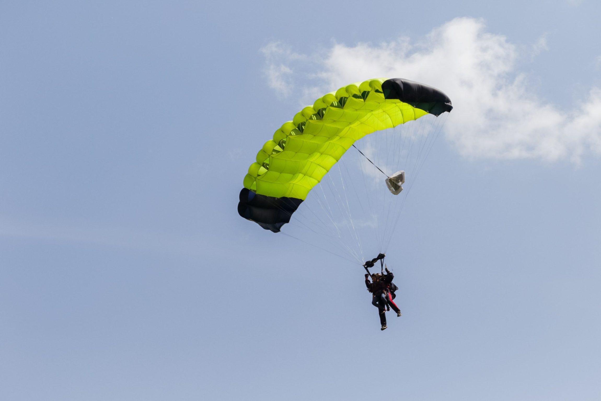 Fiundraise Events Wiggly T skydiver in the sky with a wing-type parachute